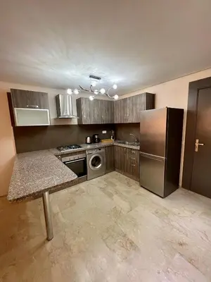 a kitchen with a stainless steel refrigerator and a dishwasher at Appartement chambre salon centre de Gueliz 22 in Marrakech
