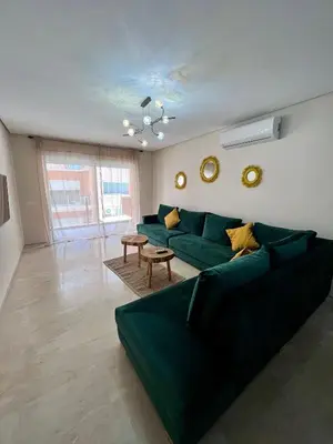 a living room with a green couch and a table at Appartement chambre salon centre de Gueliz 22 in Marrakech