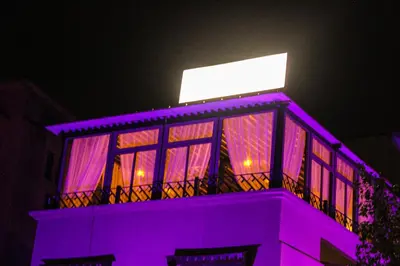 a purple building with a sign on top of it at Majorel Pearl Hotel-Riad-Restaurant Piscine&Spa in Marrakech