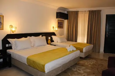 a hotel room with two beds and a window at Majorel Pearl Hotel-Riad-Restaurant Piscine&Spa in Marrakech