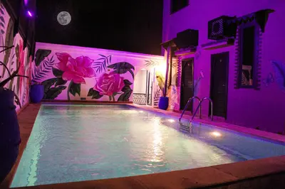 a swimming pool in a house with purple lighting at Majorel Pearl Hotel-Riad-Restaurant Piscine&Spa in Marrakech