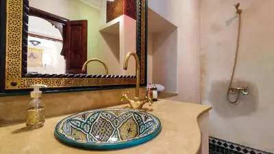 a bathroom with a sink and a mirror at RIAD DAR En-Nawat in Marrakech