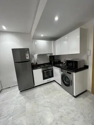 a kitchen with a refrigerator and a washer and dryer at PALACE B Av Hassan II Marrakech 40000-Specious UNIT#7 in Marrakech