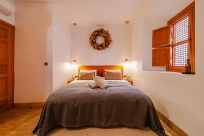 a bedroom with a bed with a wreath on the wall at RIAD THE MILESTONE in Marrakech