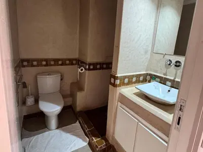 a small bathroom with a toilet and a sink at Al ATLAS résidence in Marrakech