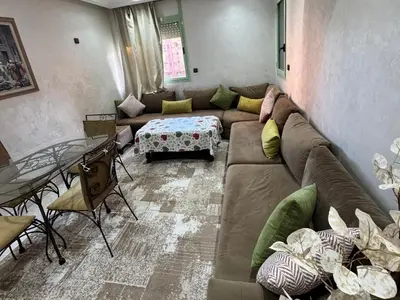 a living room with a couch and a table at Al ATLAS résidence in Marrakech