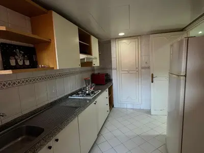 a kitchen with a sink and a refrigerator at Al ATLAS résidence in Marrakech