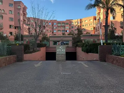 a gate to a parking lot in a city at Al ATLAS résidence in Marrakech