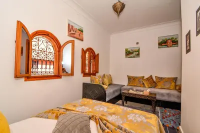 a living room with a couch and a window at Riad ouhmidi in Marrakech