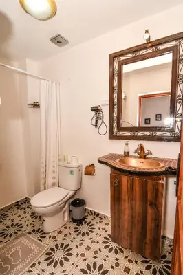 a bathroom with a sink and a toilet and a mirror at Riad ouhmidi in Marrakech