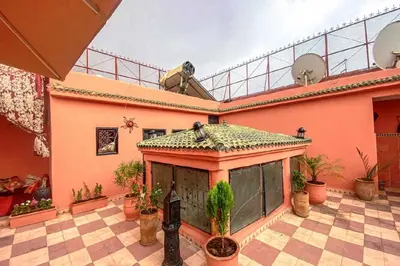 a house with a large patio with plants on it at Riad ouhmidi in Marrakech
