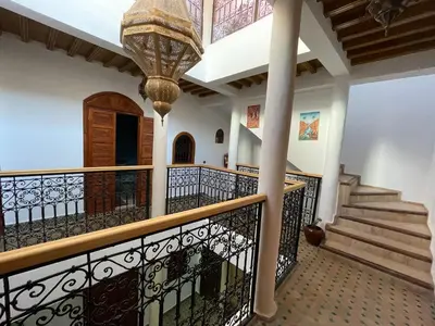 a staircase in a house with a chandelier at Riad ouhmidi in Marrakech