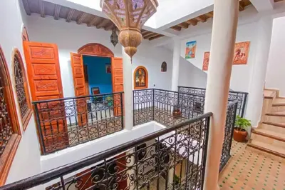 a staircase in a house with a wrought iron railing at Riad ouhmidi in Marrakech