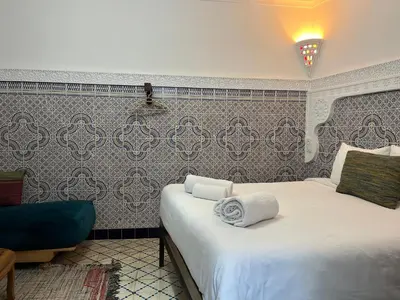 a bedroom with a bed with towels on it at Riad Imndi in Marrakech
