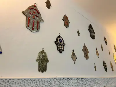 a group of cuckoo clocks hanging on a wall at Riad Imndi in Marrakech