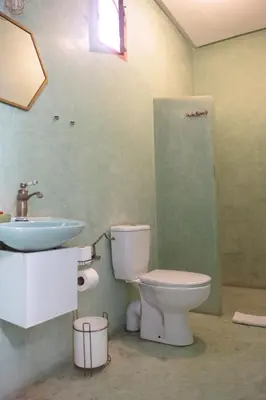 a bathroom with a toilet and a sink at Riad Imndi in Marrakech