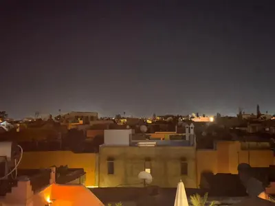 a view of a city at night at Riad Deux Palmiers in Marrakech