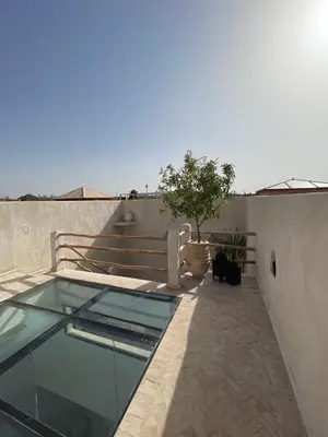 a glass pool on the side of a building at Riad Nekhla in Marrakech
