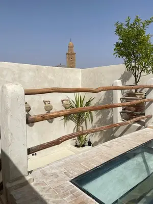 a railing on a wall next to a swimming pool at Riad Nekhla in Marrakech