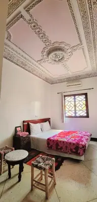 a bedroom with a bed and a coffered ceiling at Riad Marrakech Medina in Marrakech
