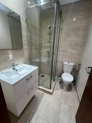 a bathroom with a shower and a sink and a toilet at Appartement Vue golf Marrakech in Marrakech