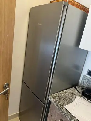 a stainless steel refrigerator in a kitchen next to a counter at Appartement Vue golf Marrakech in Marrakech