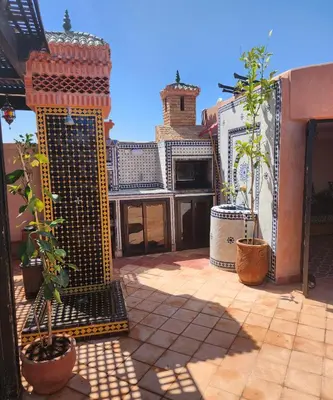 a balcony with plants in pots on a building at Atlas golf rossort in Marrakech