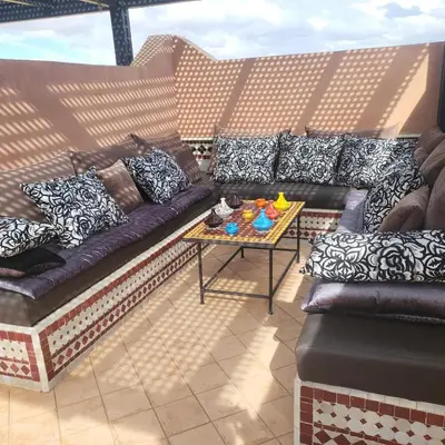a couch and a table on a balcony at Atlas golf rossort in Marrakech