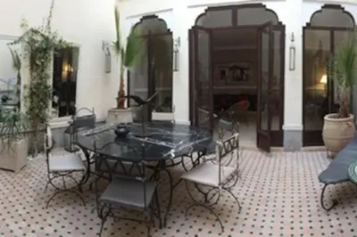 a black table and chairs in a room at Dar Nassima in Marrakech