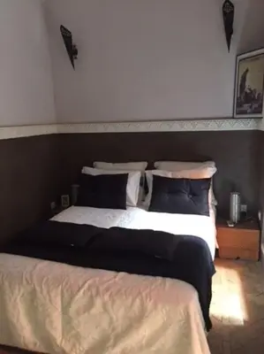 a bedroom with two beds in a room at Dar Nassima in Marrakech