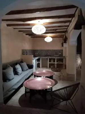 a living room with two tables and a couch at Dar Nassima in Marrakech
