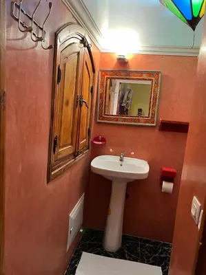 a small bathroom with a sink and a mirror at Riad Elijah Marrakech & SPA in Marrakech