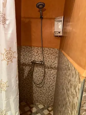 a shower with a shower head in a bathroom at Riad Elijah Marrakech & SPA in Marrakech