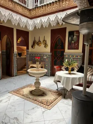 a living room with a sink and a table at Riad Elijah Marrakech & SPA in Marrakech