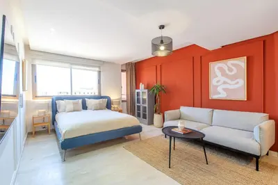a bedroom with a bed and a couch and a table at ZARI Boutique ApartHotel in Marrakech
