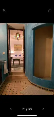a room with a blue wall and a doorway at Riad Malida Marrakech in Marrakech