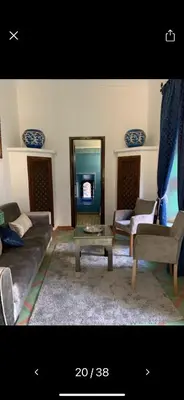 a living room with a couch and a table at Riad Malida Marrakech in Marrakech