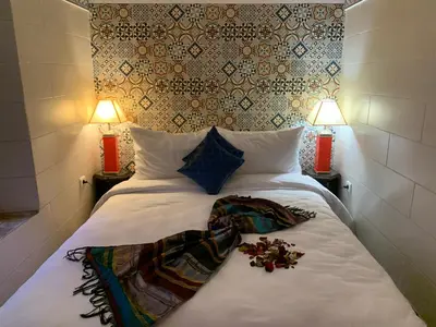 a bedroom with a white bed with flowers on it at Riad Malida Marrakech in Marrakech