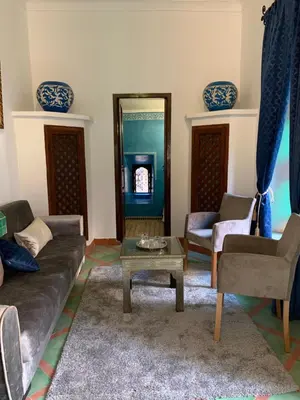a living room with a couch and a table at Riad Malida Marrakech in Marrakech