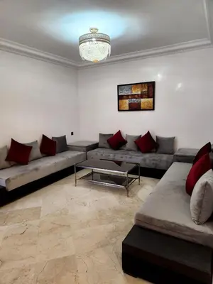 a living room with a couch and a table at Appartement en plein centre ville entièrement équipé in Marrakech