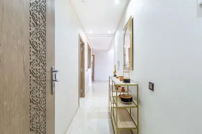 a hallway with white walls and a mirror at New! Superbe appartement à Majorelle,terrace,IPTV. in Marrakech