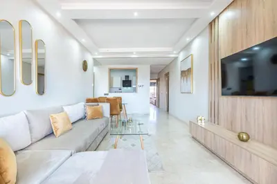 a living room with a couch and a tv at New! Superbe appartement à Majorelle,terrace,IPTV. in Marrakech