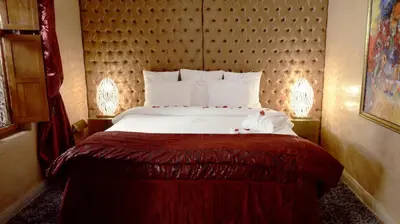 a bedroom with a large bed with a large headboard at Riad Wow in Marrakech