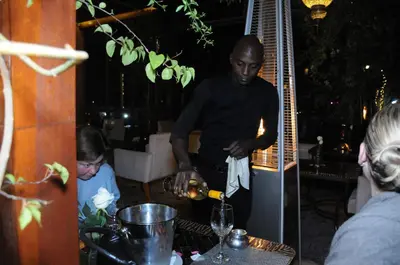 a man and a child preparing food at a table at Riad Wow in Marrakech
