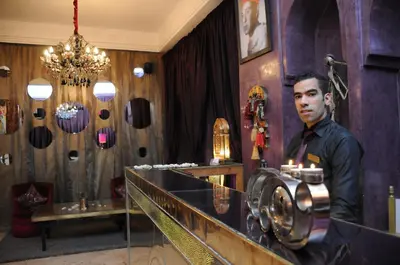 a man standing in a salon with a camera at Riad Wow in Marrakech