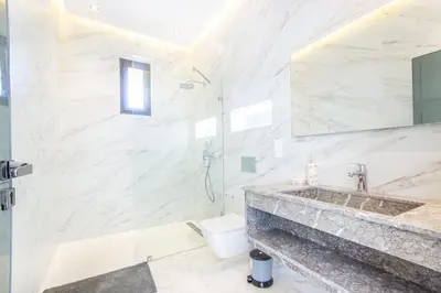 a bathroom with a shower and a sink and a toilet at Villa California, sans vis à vis, piscine Chauffée, Spa, in Marrakech