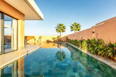 a swimming pool in the middle of a house at Villa Perle Rouge, Piscine , Cuisinière, Billard, playStation5 in Marrakech