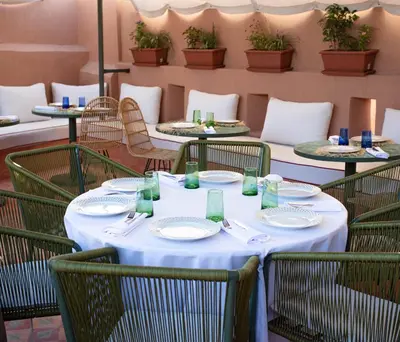a table with plates and napkins on it in a restaurant at Riad JW, La Medina autrement in Marrakech