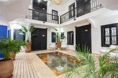 a pool in the middle of a room with plants at Riad JW, La Medina autrement in Marrakech