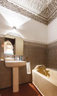 a bathroom with a sink and a tub and a mirror at Riad JW, La Medina autrement in Marrakech
